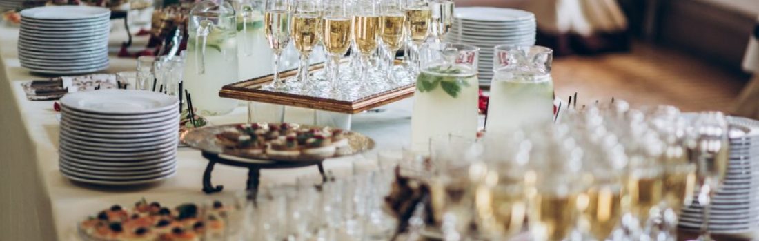 stylish champagne glasses and food  appetizers on table at wedding reception. luxury catering at celebrations. serving food and drinks at events concept